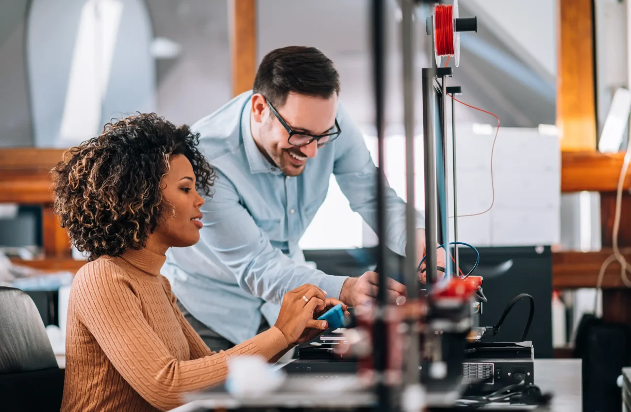 engineer-showing-to-a-young-woman-how-to-use-3d-pr-2024-10-18-05-09-12-utc